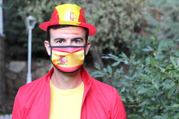 Spanish man wearing protective mask with national flag