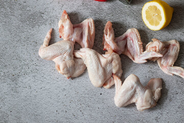 
raw chicken wings on gray background