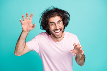 Portrait of weird person playing try to be scary palms claws isolated on turquoise color background