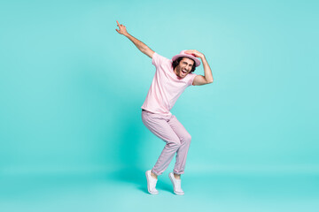 Full size profile photo of optimistic cool guy dancing wear spectacles pastel pink cap t-shirt pants sneakers isolated on teal background