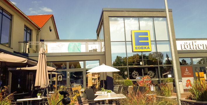 Petershagen, Germany- July 3, 2019: Edeka shop logo and shop centre.
