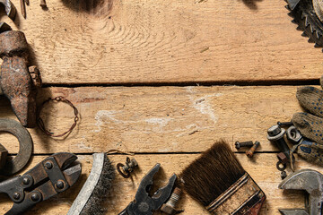 Old vintage household hand tools on a wooden background as frame and place for text
