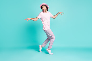 Fototapeta na wymiar Full length profile photo of cheerful guy hush steps hiding making surprise wear spectacles cap pants t-shirt isolated teal color background