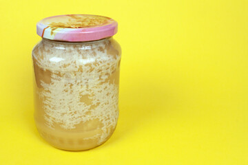 a dish of hardened honey on a yellow background