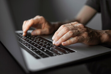 Man hands typing on computer keyboard closeup, businessman or student using laptop at home, online...