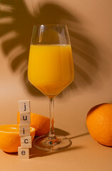 fresh orange juice with pulp in a wine glass. on a coffee background. with beautiful shadows