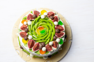 Holiday cake decorated with white cream and fruits