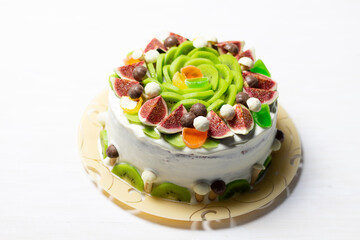 Holiday cake decorated with white cream, berries and fruits