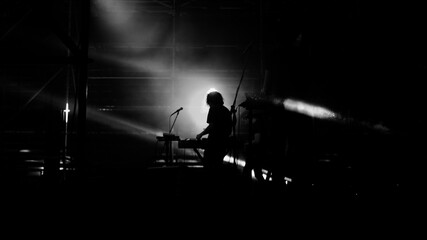 silhouette of a man playing piano