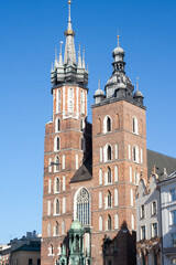 Fototapeta na wymiar Krakow, Poland - February 17, 2019: Old city center view with Adam Mickiewicz monument and St. Mary's Basilica in Krakow