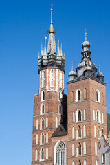 Fototapeta na wymiar Old city center view with Adam Mickiewicz monument and St. Mary's Basilica in Krakow