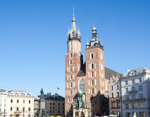 Old city center view with Adam Mickiewicz monument and St. Mary's Basilica in Krakow