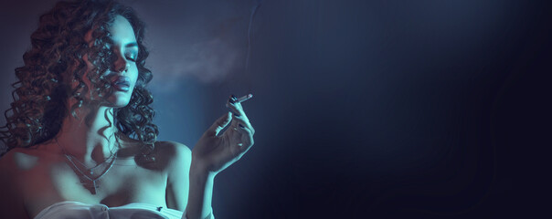 Beautiful smoking young woman, closeup portrait, at night. Beauty fashion sexy model girl with...