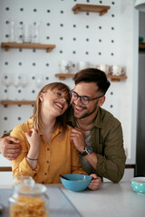 Young couple eating breakfast at home. Loving couple enjoying in the kitchen...
