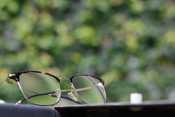 Fototapeta na wymiar Eyeglasses on natural background. Lifestyle concept.