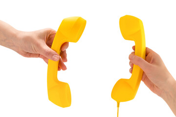 Yellow handset in woman hand isolated on white.