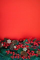 Christmas decorations on the red background. Top view with copy space for your text. Vertical photo.