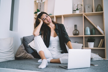 Happy woman using laptop at home