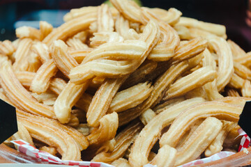 sweet churros and alfajores for sale at the street fair in spain