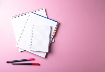 notebooks on pink
