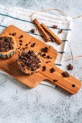 Vanilla caramel muffins with chocolate pieces on a wooden Board, beautiful dessert background image with space for text