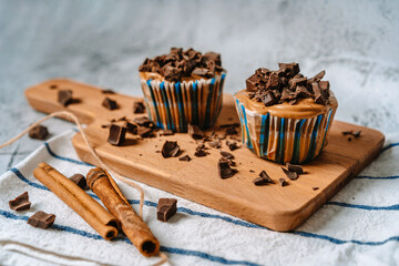 Vanilla caramel muffins with chocolate pieces on a wooden Board, beautiful dessert background image with space for text