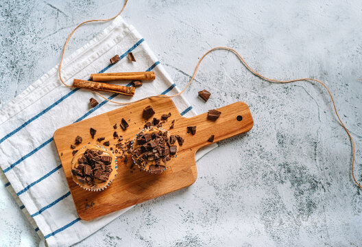 Vanilla caramel muffins with chocolate pieces on a wooden Board, beautiful dessert background image with space for text