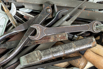 A box with a set of old rusty locksmith tools.