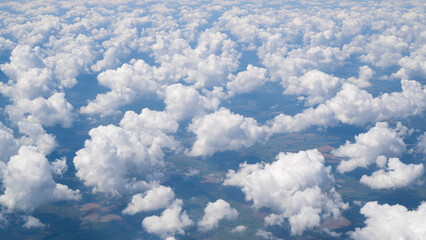 View from plane. Aerial view of the small city, ground and clouds from the aircraft during the flight. Concept travel.