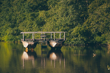 Obraz premium rural landscape with old wooden boat on a lake