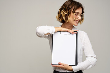 Business woman with folder of documents in hands on gray background cropped view of work