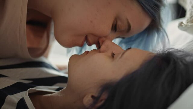 Close up video of lesbian couple intimately kissing in bed. Shot with RED helium camera in 8K