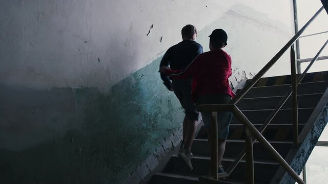 Teenage boy attacked by thug in abandoned building, gang violence and bullying concept.