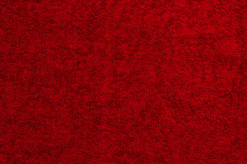 Fototapeta premium red cotton terry towel lies on a flat surface close-up