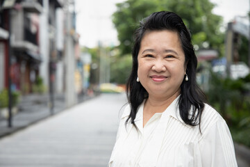 happy friendly asian old senior woman smiling at you