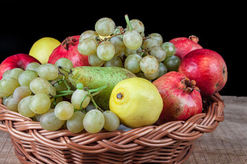 pomegranates and other fruit in the basket