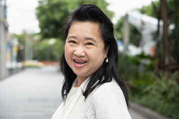 happy friendly asian old senior woman smiling at you