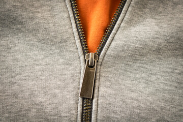 Metal zipper on the sports jacket. Close up. Selective focus.