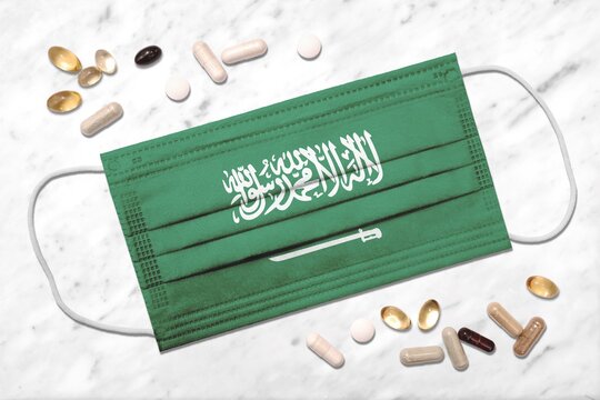 Face mask with flag of Saudi Arabia during coronavirus pandemic