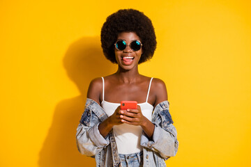 Photo of pretty shiny young woman wear casual jeans clothes holding gadget naked shoulders isolated...