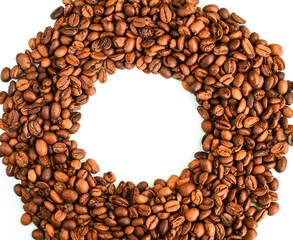 Circle frame of coffee beans isolated on a light background. Roasted coffee beans background, place for your text.