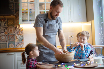 Young family making cookies at home