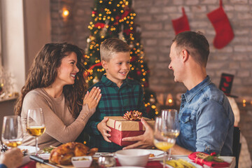 Parents giving Christmas present to their child