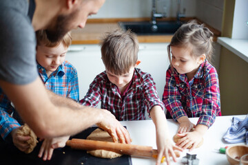 Young family making cookies at home