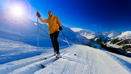 Woman country skiers on a sunny winter morning in Alps, 