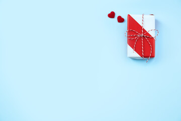 Valentine's Day greeting design concept - Top view of gift box on bright blue background.