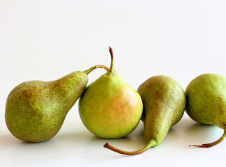Juicy, flavorful, tasty pears on the white wooden background. Pear autumn harvest. Free space for text. Autumn nature concept.