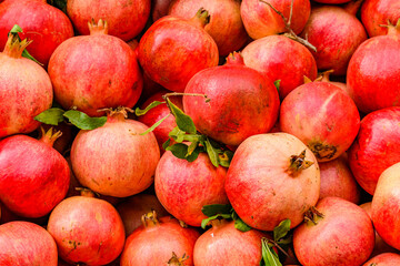 Many pomegranates for sale at the market. Fruit background