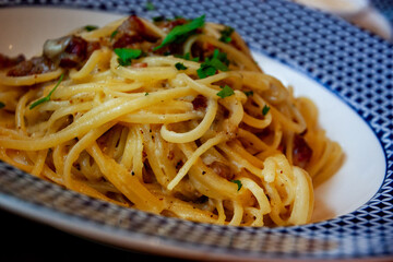 Cooked Linguini pasta, ready to eat,in white and blue plate