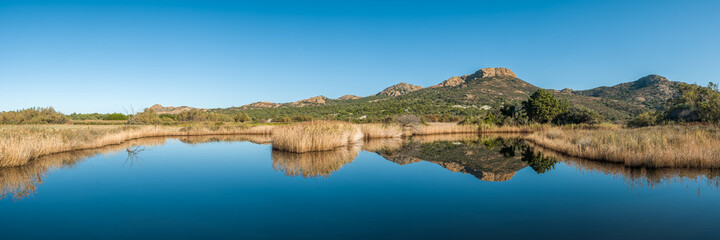 Fototapeta na wymiar Reflections in a lake at Ostriconi in Corsica